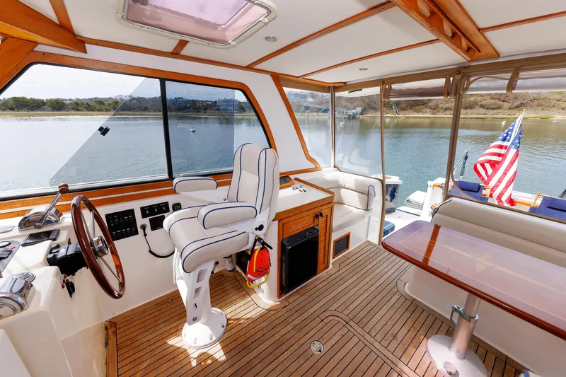 Slide: The Image of Interior of 2004 Sabre 42 Express yacht with helm, seating, and American flag. - 19