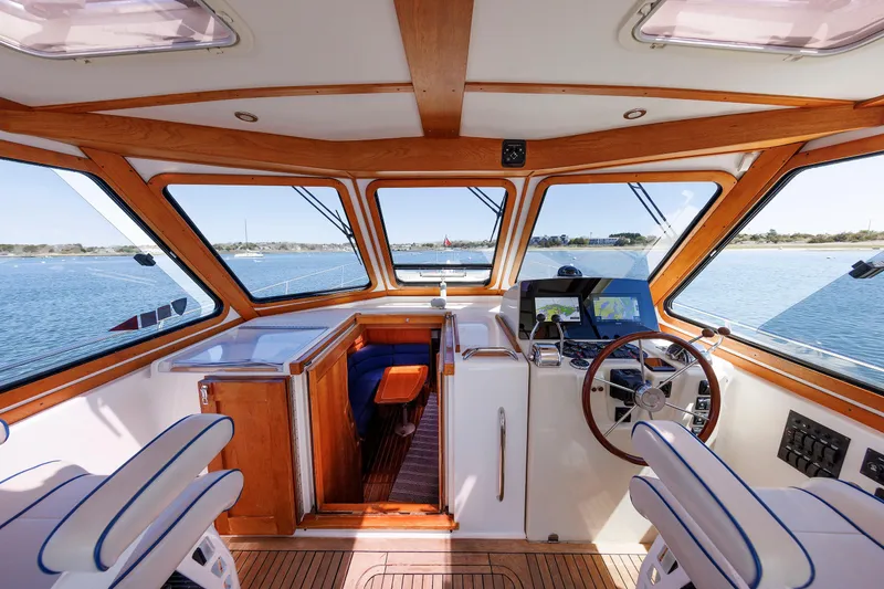Slide: The Image of Interior view of 2004 Sabre 42 Express yacht helm with wooden accents and navigation equipment. - 20