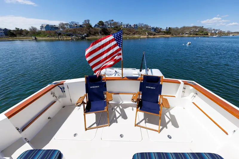 Slide: The Image of Deck of 2004 Sabre 42 Express yacht with chairs and American flag. - 23