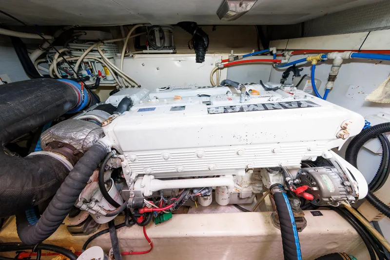Slide: The Image of Engine room of a 2004 Sabre 42 Express boat, featuring a Yanmar engine. - 28