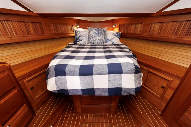 Slide: The Image of Cozy cabin interior of 2004 Sabre 42 Express with checkered bedding and wooden finish. - 6