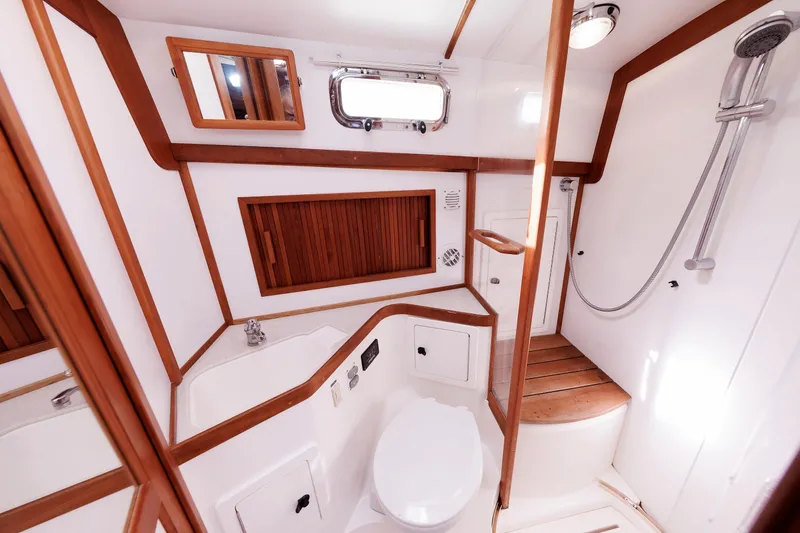 Slide: The Image of Luxurious 2004 Sabre 42 Express yacht bathroom with wood accents and modern fixtures. - 7