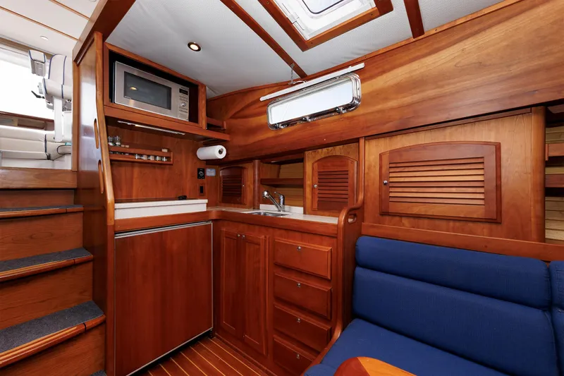 Slide: The Image of Interior of 2004 Sabre 42 Express yacht with wooden cabinetry and compact kitchen area. - 8