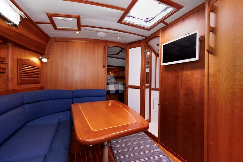 Slide: The Image of Luxurious interior of 2004 Sabre 42 Express yacht with wood finish and blue seating. - 9