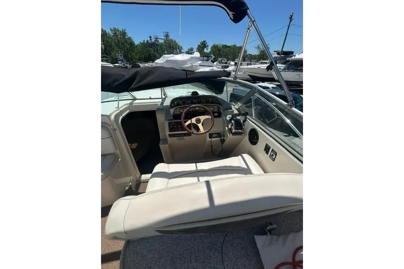 Slide: The Image of 2001 Rinker 310 Express Cruiser cockpit with steering wheel and dashboard controls. - 11