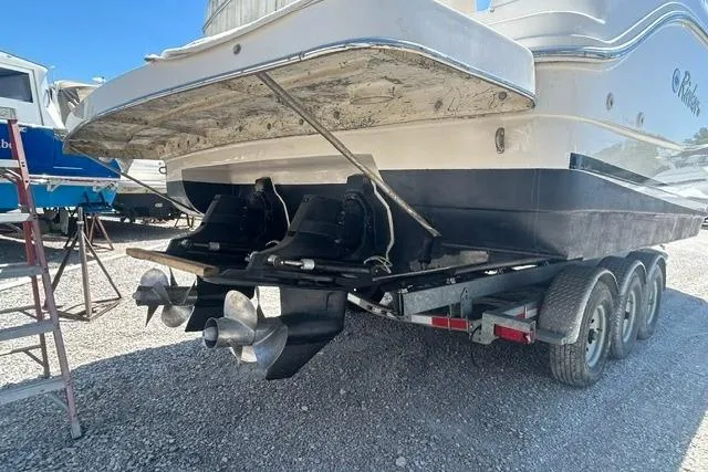 Slide: The Image of 2001 Rinker 310 Express Cruiser on trailer, rear view showing dual propellers. - 20