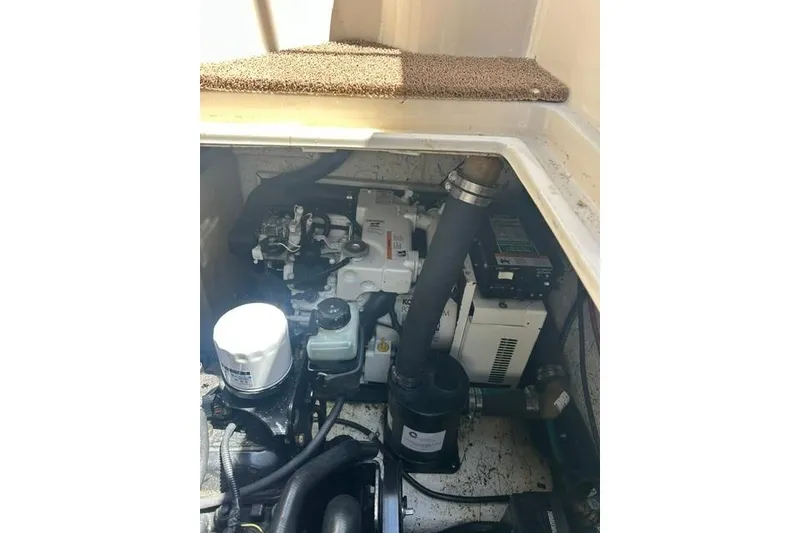 Slide: The Image of Engine compartment of a 2001 Rinker 310 Express Cruiser, showcasing mechanical components. - 24