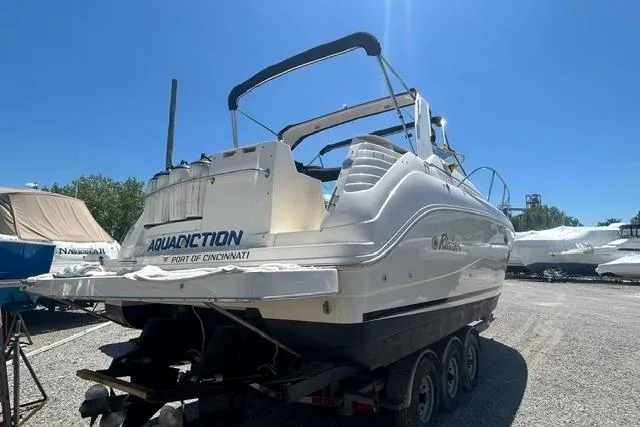 Slide: The Image of 2001 Rinker 310 Express Cruiser on trailer under clear blue sky. - 3