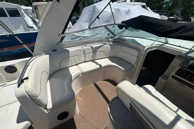 Slide: The Image of 2001 Rinker 310 Express Cruiser with white seating and spacious cockpit area. - 9