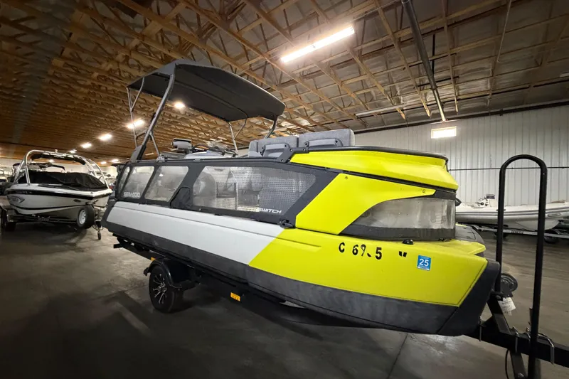 Slide: The Image of 2022 Sea-Doo Switch Cruise 21 pontoon boat in a storage facility. - 3