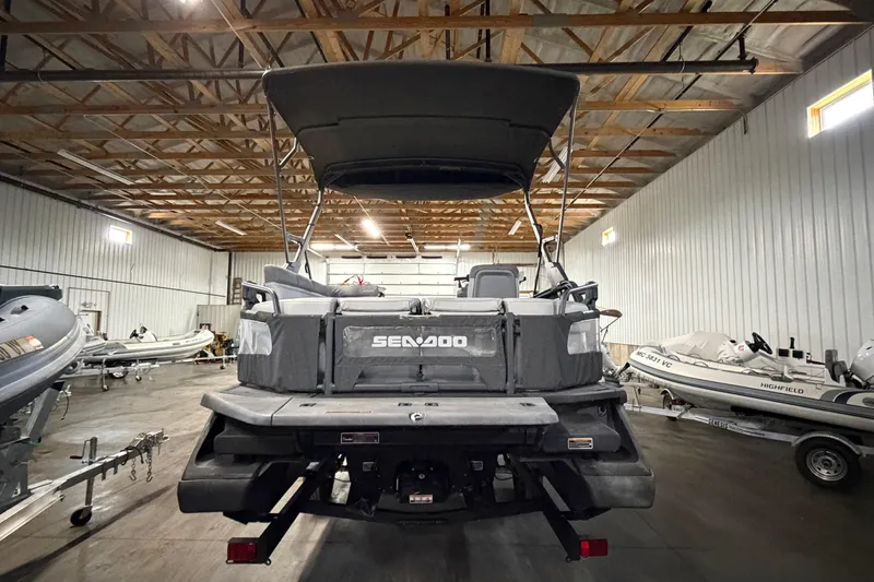 Slide: The Image of 2022 Sea-Doo Switch Cruise 21 pontoon boat in a storage facility. - 4