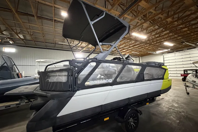 Slide: The Image of 2022 Sea-Doo Switch Cruise 21 pontoon boat in a warehouse setting. - 5