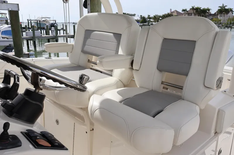 Slide: The Image of 2021 Pursuit S 328 Sport boat helm with luxurious seating and controls. - 12