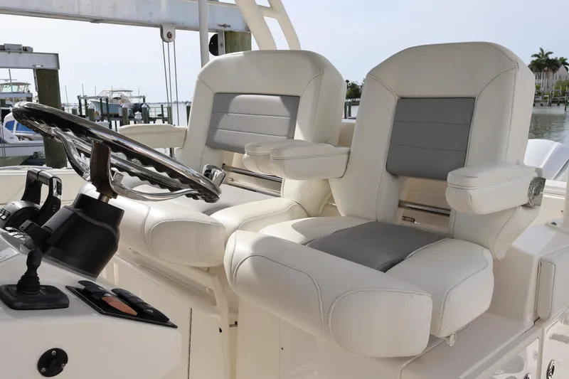 Slide: The Image of Luxury helm seats on 2021 Pursuit S 328 Sport boat, featuring sleek design and comfort. - 14