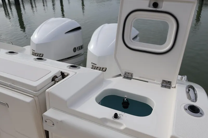Slide: The Image of 2021 Pursuit S 328 Sport boat with Yamaha 300 engines and open storage compartment. - 29