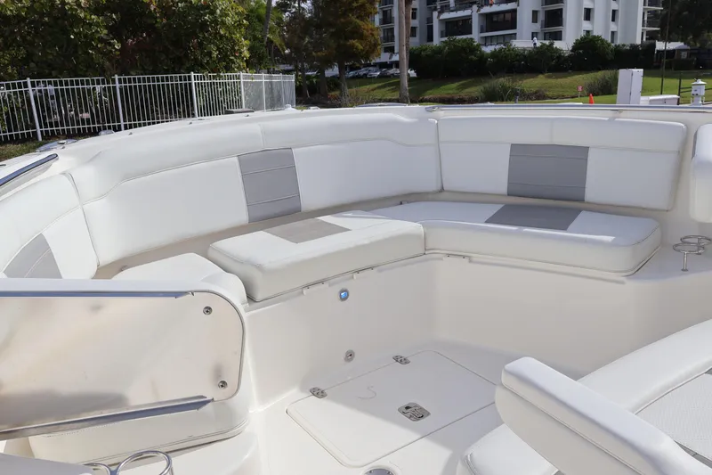 Slide: The Image of 2021 Pursuit S 328 Sport boat interior with white cushioned seating and modern design. - 46