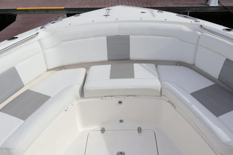 Slide: The Image of 2021 Pursuit S 328 Sport boat with white and gray cushioned seating. - 48