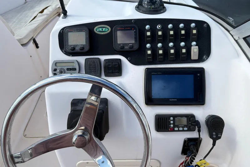 Slide: The Image of 2008 Grady-White Tournament 205 boat dashboard with steering wheel and navigation instruments. - 12