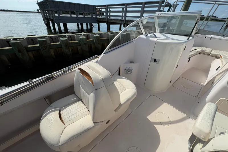 Slide: The Image of 2008 Grady-White Tournament 205 boat interior with seating and dock view. - 13