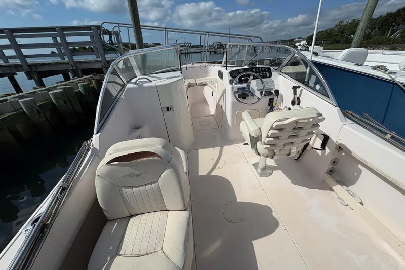 Slide: The Image of 2008 Grady-White Tournament 205 boat interior with helm and seating, docked by the pier. - 15