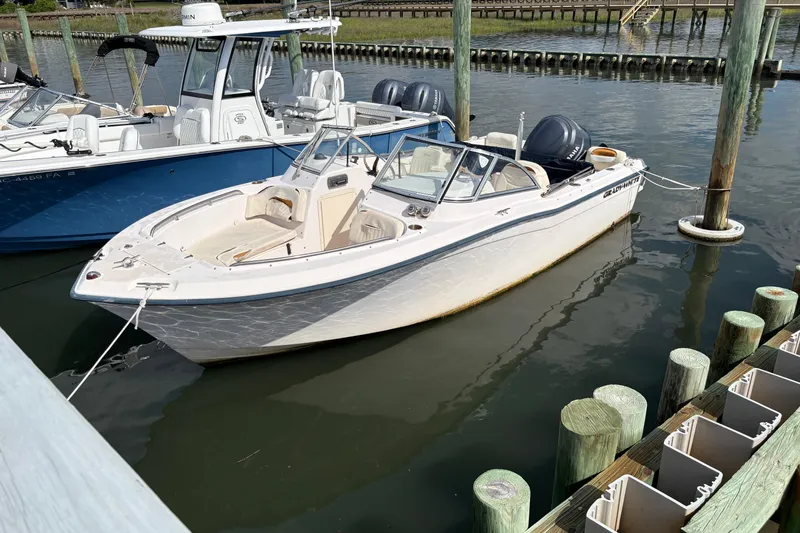 Slide: The Image of 2008 Grady-White Tournament 205 boat docked in marina, featuring dual engines. - 2