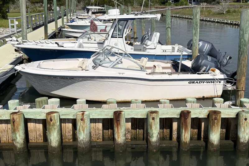 Slide: The Image of 2008 Grady-White Tournament 205 boat docked at a marina with other vessels. - 3
