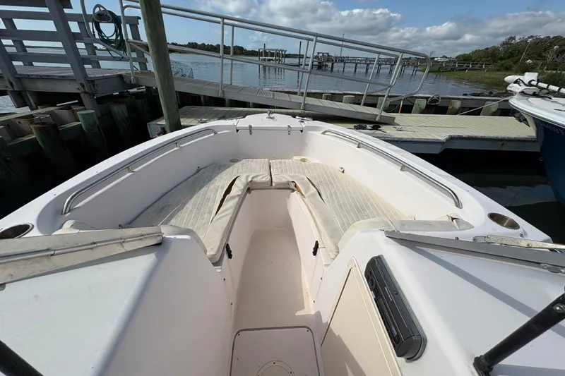 Slide: The Image of 2008 Grady-White Tournament 205 boat docked, featuring spacious seating and scenic waterfront view. - 4