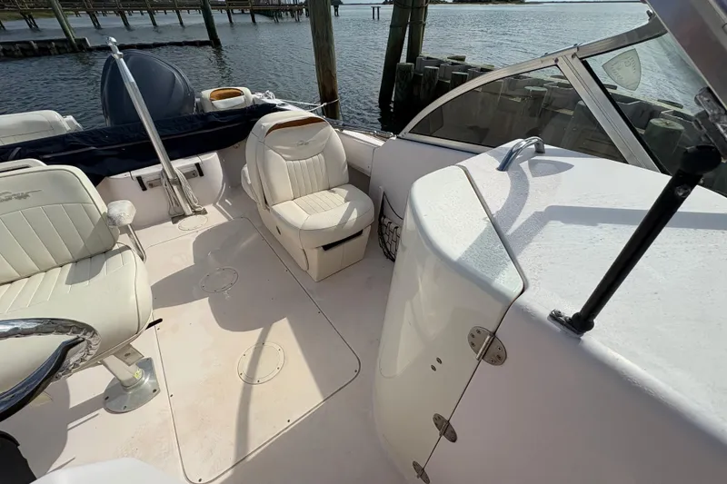 Slide: The Image of 2008 Grady-White Tournament 205 boat interior with white seating and open deck. - 7