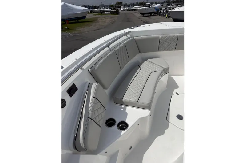 Slide: The Image of 2023 Pursuit S 428 Sport boat interior with luxurious seating and cup holders. - 12