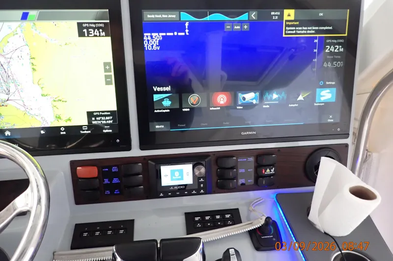 Slide: The Image of Helm of 2023 Pursuit S 428 Sport with Garmin navigation displays and controls. - 18