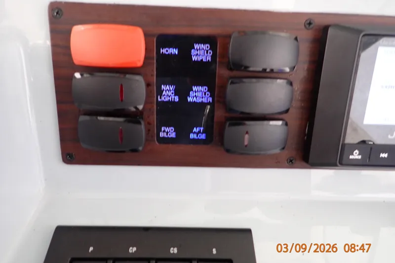Slide: The Image of Control panel of a 2023 Pursuit S 428 Sport boat with labeled switches. - 19
