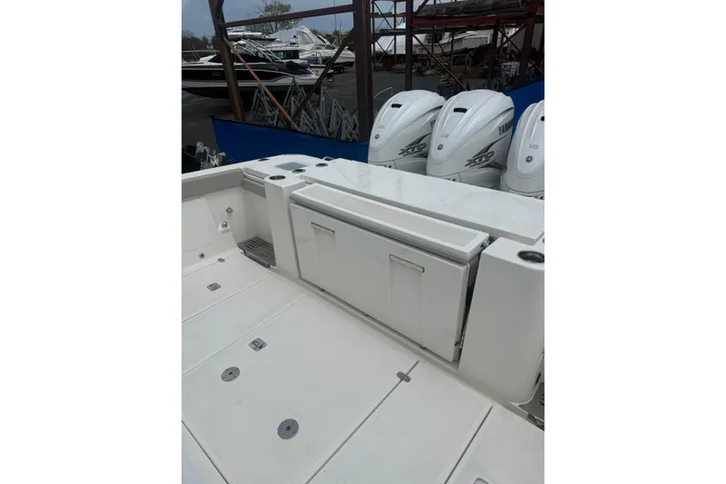 Slide: The Image of 2023 Pursuit S 428 Sport boat with Yamaha outboard engines in a marina setting. - 2