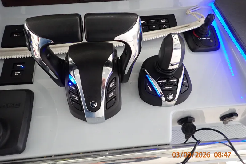 Slide: The Image of Control panel of a 2023 Pursuit S 428 Sport boat with advanced joystick and throttle controls. - 20