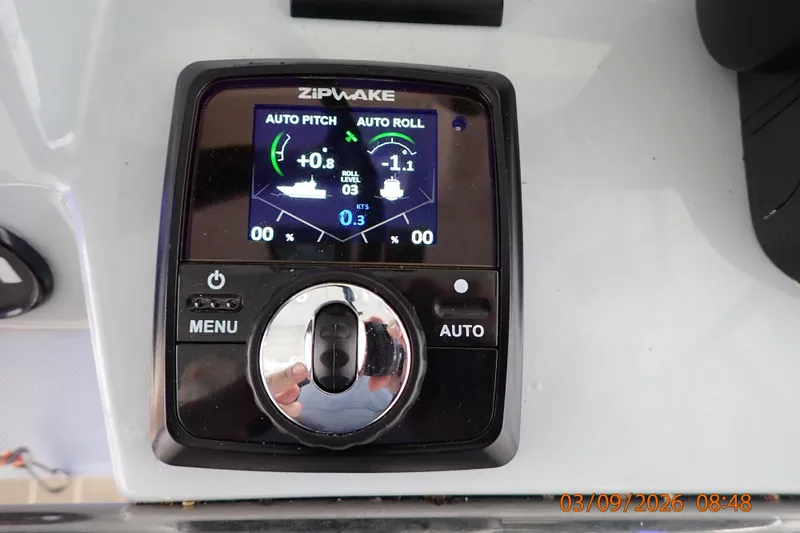Slide: The Image of Control panel of a 2023 Pursuit S 428 Sport boat with auto pitch and roll settings. - 21