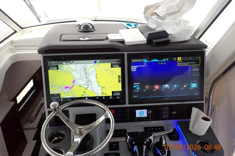 Slide: The Image of 2023 Pursuit S 428 Sport boat dashboard with navigation screens and controls. - 22
