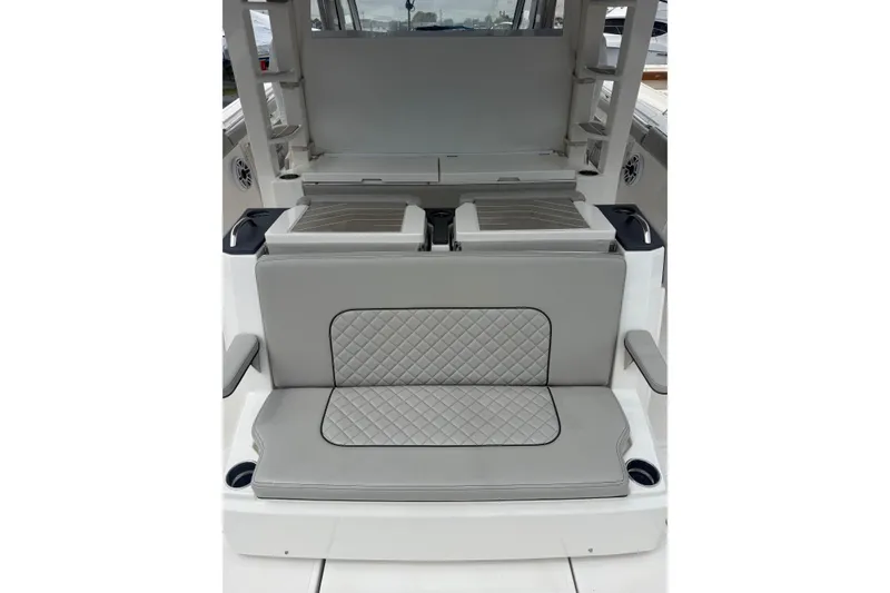 Slide: The Image of 2023 Pursuit S 428 Sport boat interior with gray quilted seating and cup holders. - 4