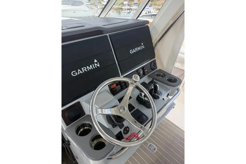 Slide: The Image of Helm of 2023 Pursuit S 428 Sport boat with Garmin displays and controls. - 8