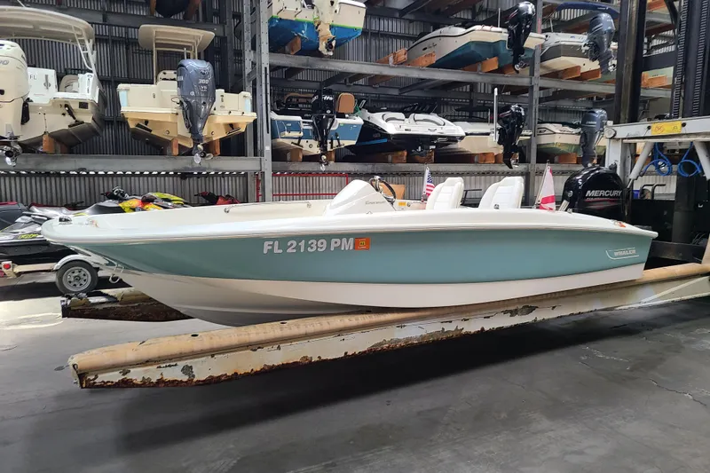The Image of 2013 Boston Whaler 170 Super Sport boat in storage, side view with visible registration number. - 0