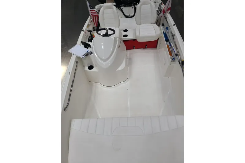 Slide: The Image of 2013 Boston Whaler 170 Super Sport interior with white seating and steering console. - 11