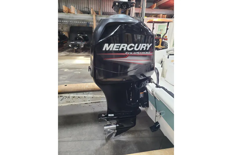 Slide: The Image of Mercury FourStroke engine on 2013 Boston Whaler 170 Super Sport boat in a garage. - 16