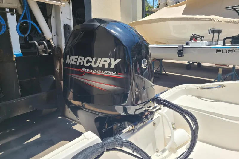 Slide: The Image of Mercury FourStroke engine on 2013 Boston Whaler 170 Super Sport boat in marina. - 17