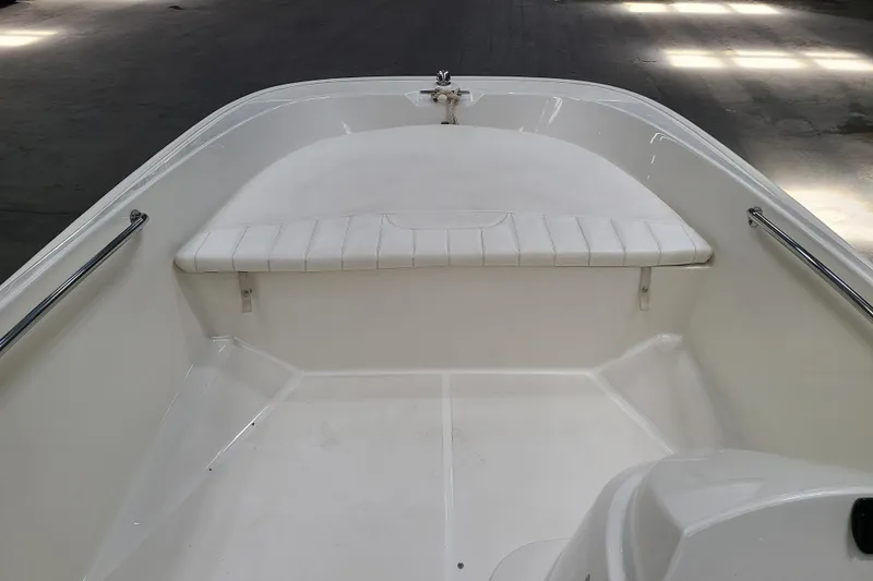 Slide: The Image of 2013 Boston Whaler 170 Super Sport boat interior with white seating and railings. - 6