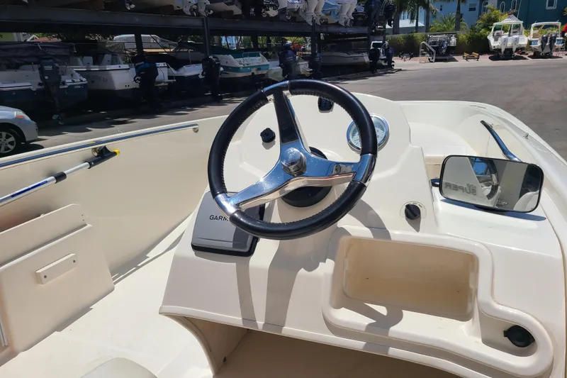 Slide: The Image of 2013 Boston Whaler 170 Super Sport boat dashboard with steering wheel and Garmin device. - 7