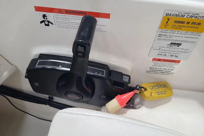 Slide: The Image of Control panel of a 2013 Boston Whaler 170 Super Sport boat with safety warnings. - 9