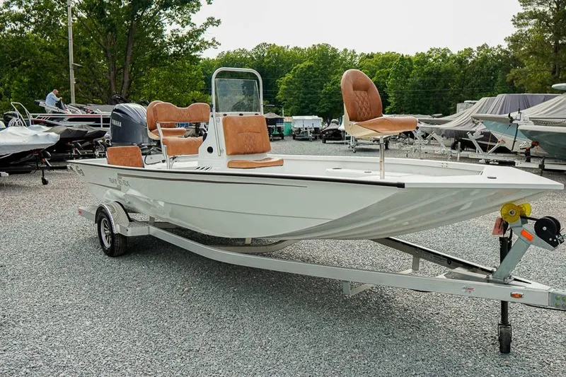 The Image of 2026 G3 Bay 21 GX Tunnel boat on trailer, featuring tan seats and Yamaha engine. - 1