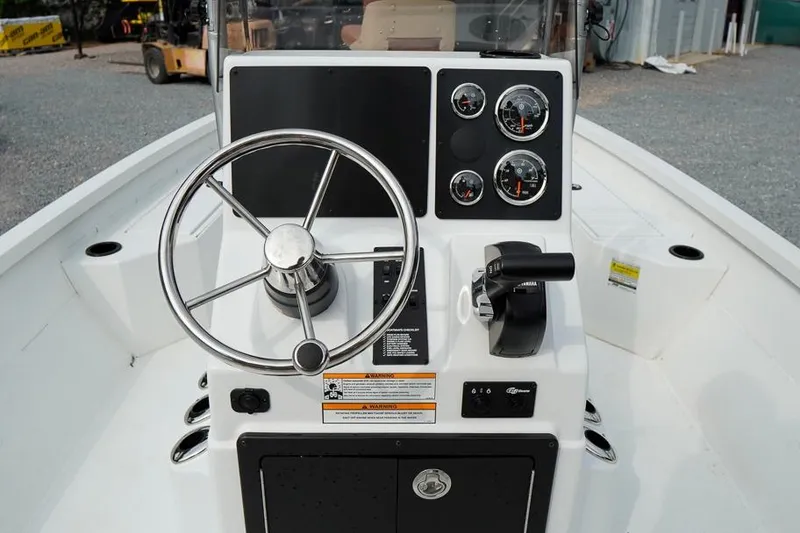Slide: The Image of Center console of 2026 G3 Bay 21 GX Tunnel boat with steering wheel and gauges. - 10