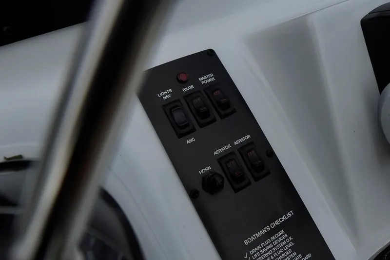 Slide: The Image of Control panel of 2026 G3 Bay 21 GX Tunnel boat with switches and checklist. - 12
