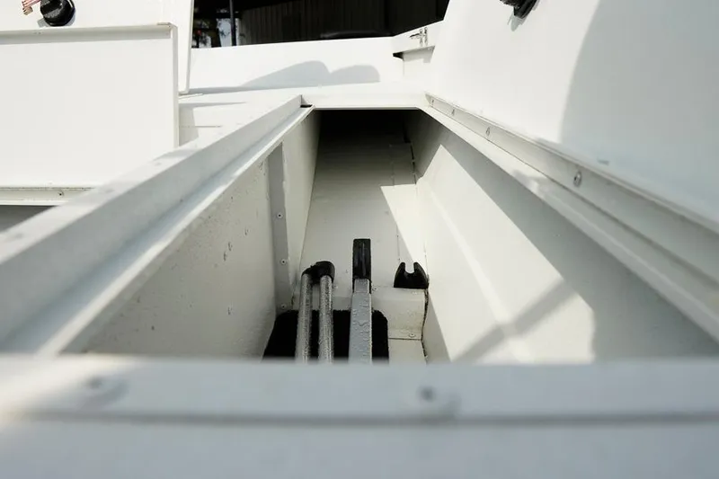 Slide: The Image of 2026 G3 Bay 21 GX Tunnel boat interior storage compartment with cables. - 24