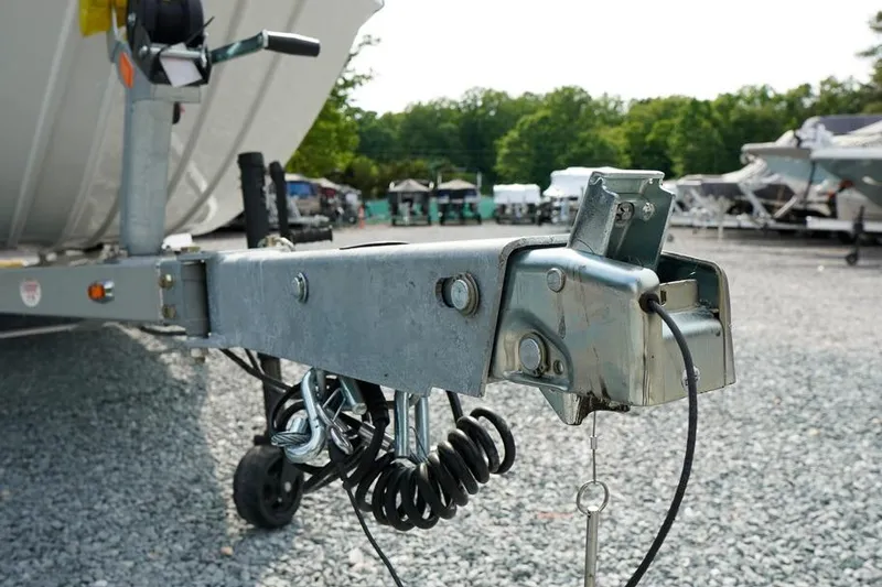 Slide: The Image of Trailer hitch of 2026 G3 Bay 21 GX Tunnel boat on gravel lot. - 29