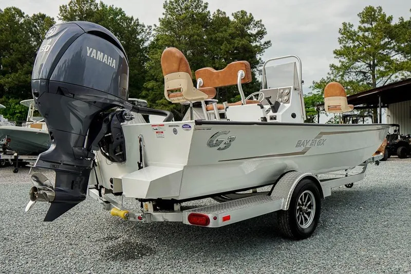 Slide: The Image of 2026 G3 Bay 21 GX Tunnel boat with Yamaha engine on trailer, parked outdoors. - 3